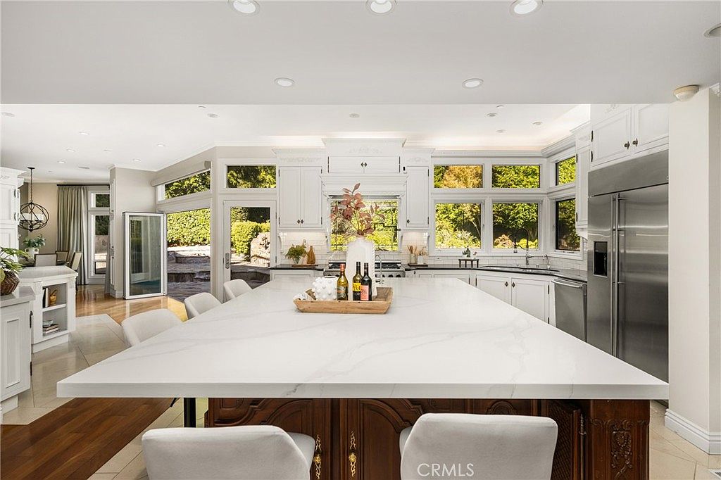 Great room with stone fireplace and bi-fold sliders to the grounds