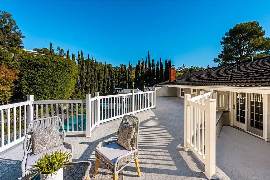 Private deck overlooking the pool with cypress trees